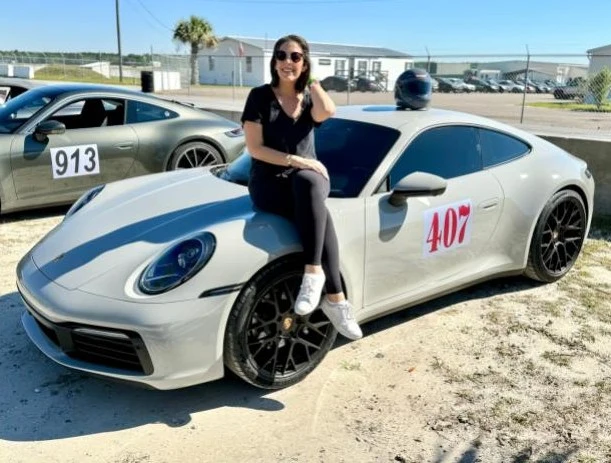 Giovanna Barrios beside a sports car in a photograph from the publisher’s archive