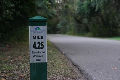 A paved path and trail marker on the Seminole Wekiva Trail