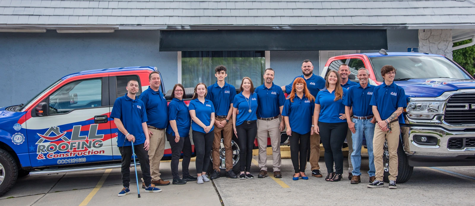 The All Roofing & Construction team outside the company building